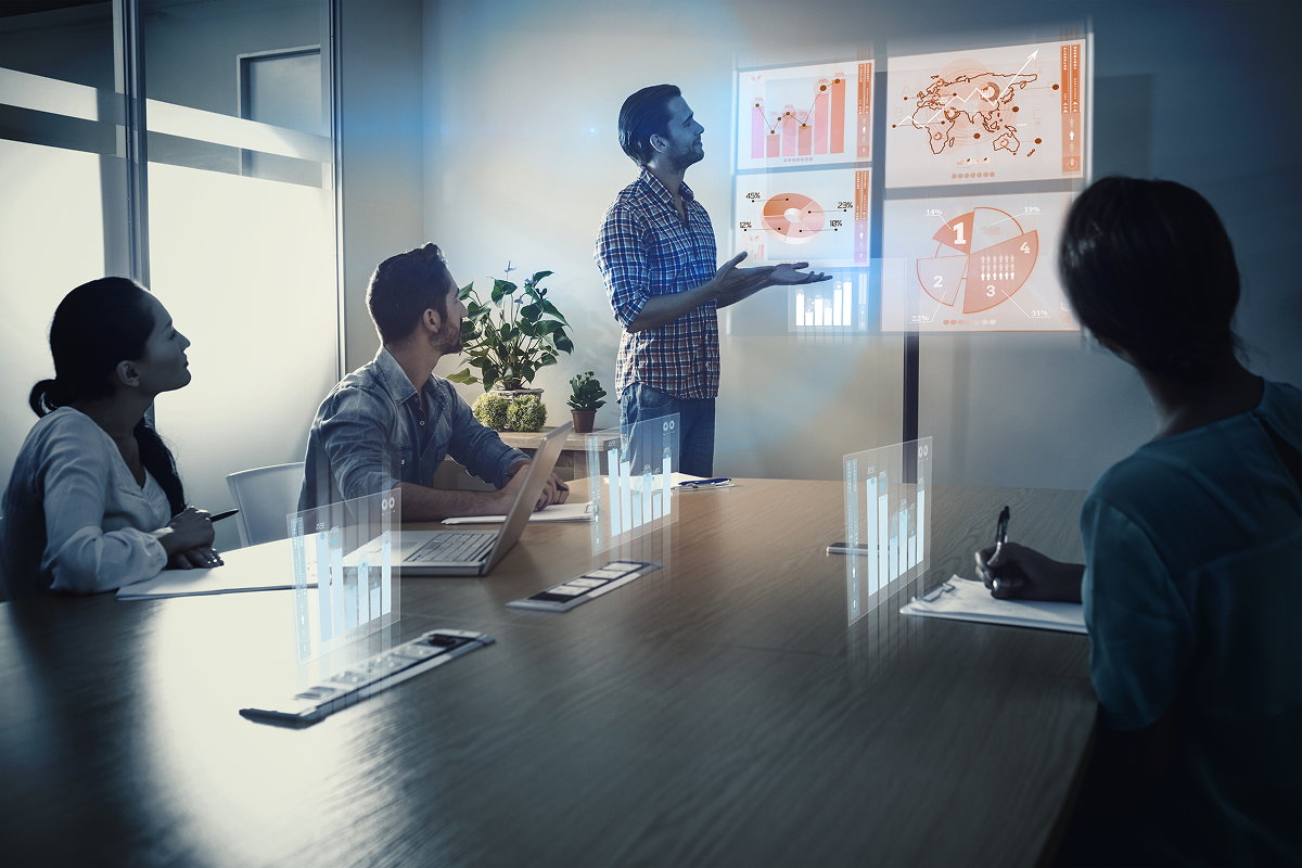 Team collaborating on a project with laptops and charts